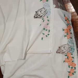 Vintage pair of pillowcases with embroidered praying hands